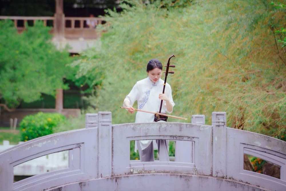 藝術家形象照作品 — 身著白衣的二胡演奏者於石橋上的戶外形象拍攝